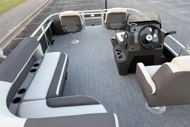 Slide: The Image of 2026 Sun Tracker Bass Buggy 18 DLX pontoon boat interior with seating and steering console. - 20