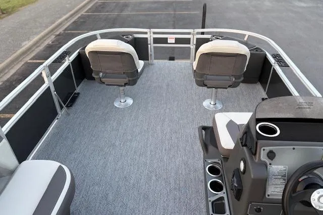 Slide: The Image of 2026 Sun Tracker Bass Buggy 18 DLX pontoon boat interior with seating and steering console. - 21