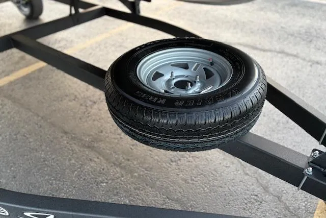 Slide: The Image of Spare tire mounted on a 2026 Sun Tracker Bass Buggy 18 DLX trailer. - 26