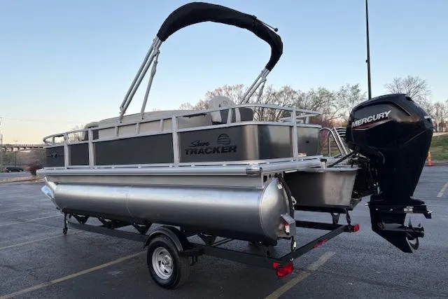 Slide: The Image of 2026 Sun Tracker Bass Buggy 18 DLX pontoon boat with Mercury outboard motor on trailer. - 5