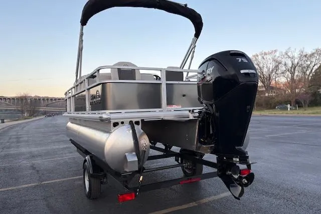 Slide: The Image of 2026 Sun Tracker Bass Buggy 18 DLX pontoon boat with Mercury outboard motor on trailer. - 8