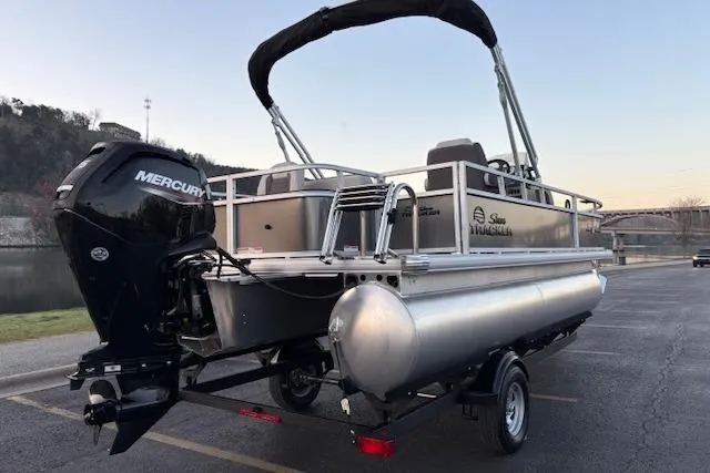Slide: The Image of 2026 Sun Tracker Bass Buggy 18 DLX pontoon boat with Mercury engine on trailer. - 9