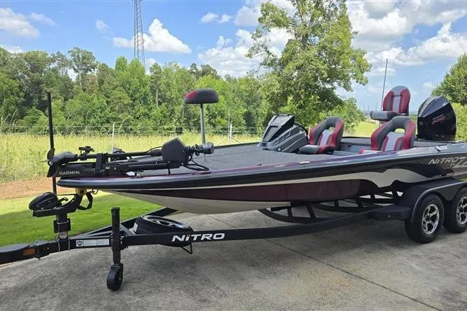 Slide: The Image of 2026 Nitro Z20 XL Pro bass boat on trailer, parked outdoors, under a clear blue sky. - 5
