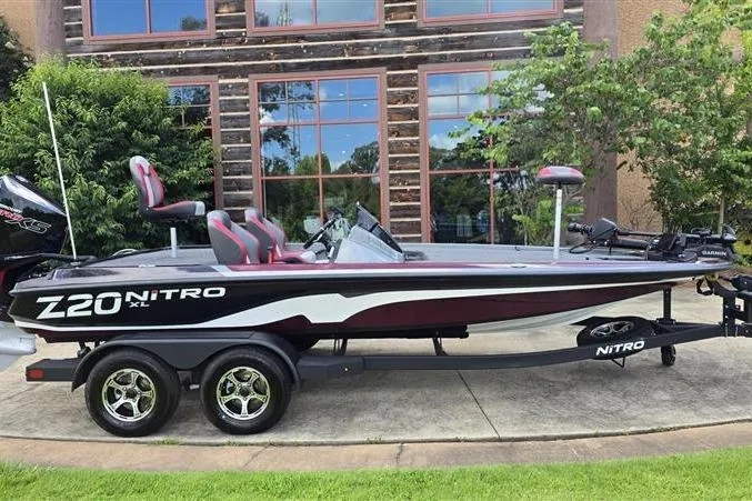 The Image of 2026 Nitro Z20 XL Pro bass boat on trailer, parked outdoors. - 0