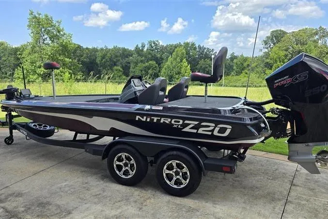 Slide: The Image of 2026 Nitro Z20 XL Pro bass boat on trailer, parked outdoors with scenic background. - 4