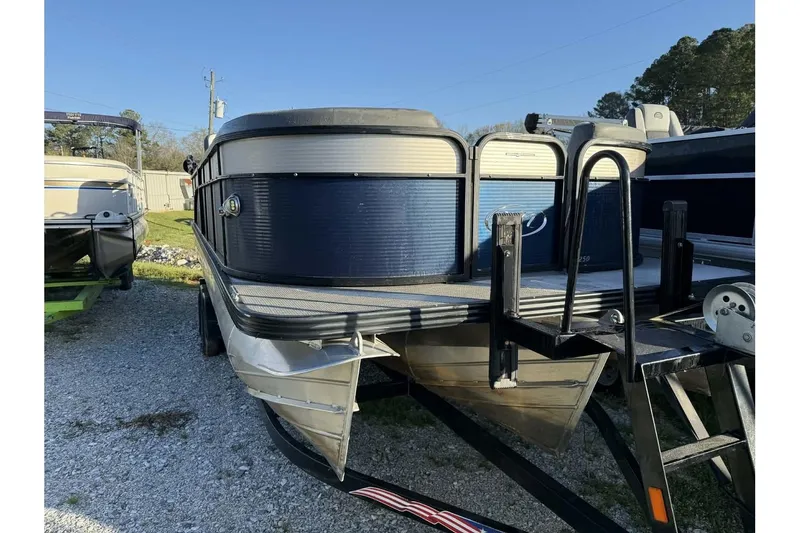 Slide: The Image of 2022 Manitou 25 Aurora pontoon boat on trailer, parked outdoors. - 10