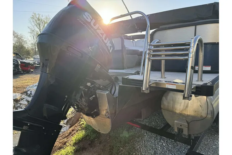 Slide: The Image of 2022 Manitou 25 Aurora pontoon boat with Suzuki outboard motor and ladder. - 11