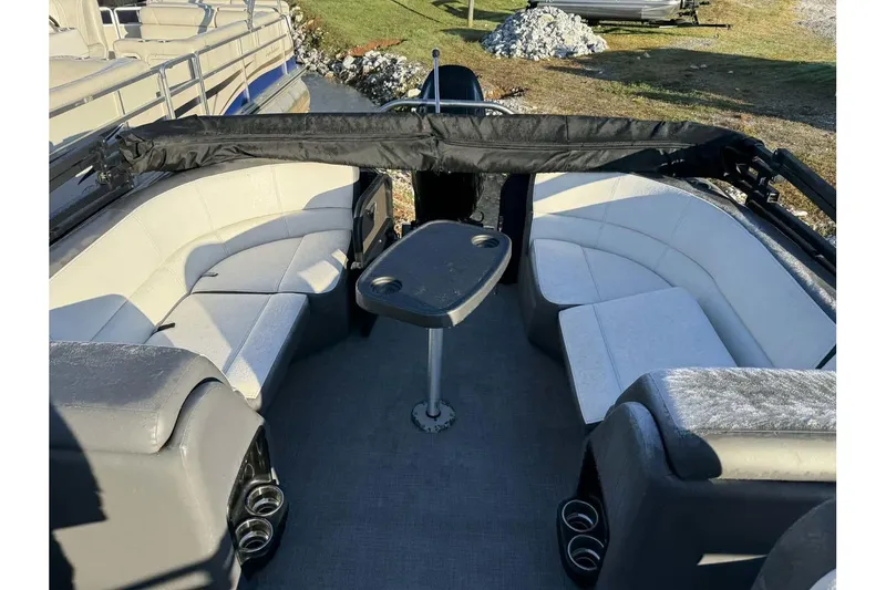 Slide: The Image of 2022 Manitou 25 Aurora pontoon boat interior with seating and table. - 5