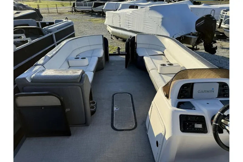 Slide: The Image of 2022 Manitou 25 Aurora pontoon boat interior with seating and Garmin dashboard. - 8