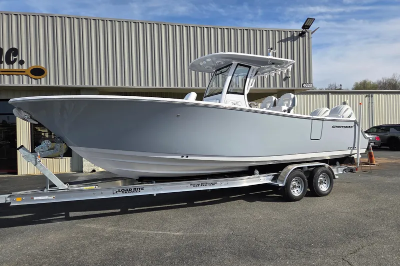 The Image of 2026 Sportsman Heritage 261 Center Console boat on trailer outside a building. - 0
