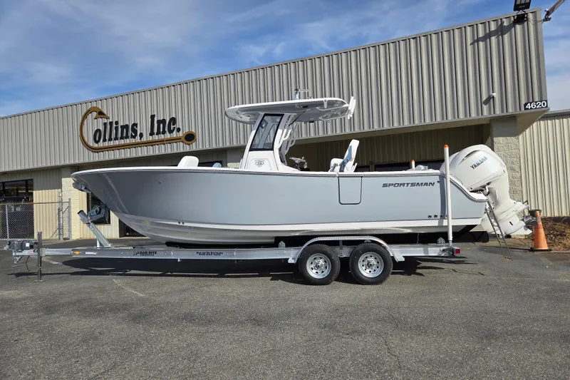 Slide: The Image of 2026 Sportsman Heritage 261 Center Console boat on trailer outside Collins Inc. building. - 1