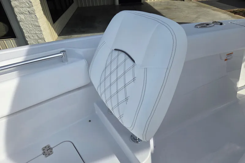 Slide: The Image of White cushioned seat on 2026 Sportsman Heritage 261 Center Console boat. - 11