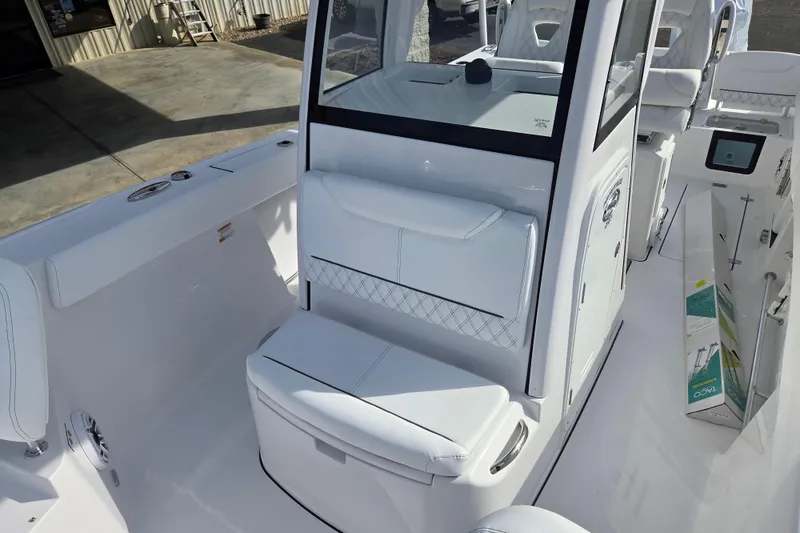 Slide: The Image of 2026 Sportsman Heritage 261 Center Console boat interior with white seating and modern design. - 12