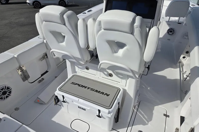 Slide: The Image of 2026 Sportsman Heritage 261 Center Console boat interior with white seating and storage. - 14