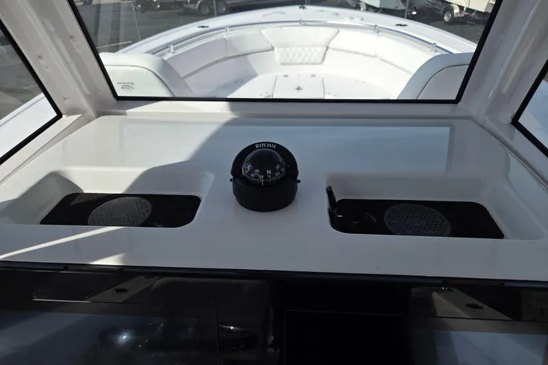 Slide: The Image of 2026 Sportsman Heritage 261 Center Console dashboard with compass and storage compartments. - 16