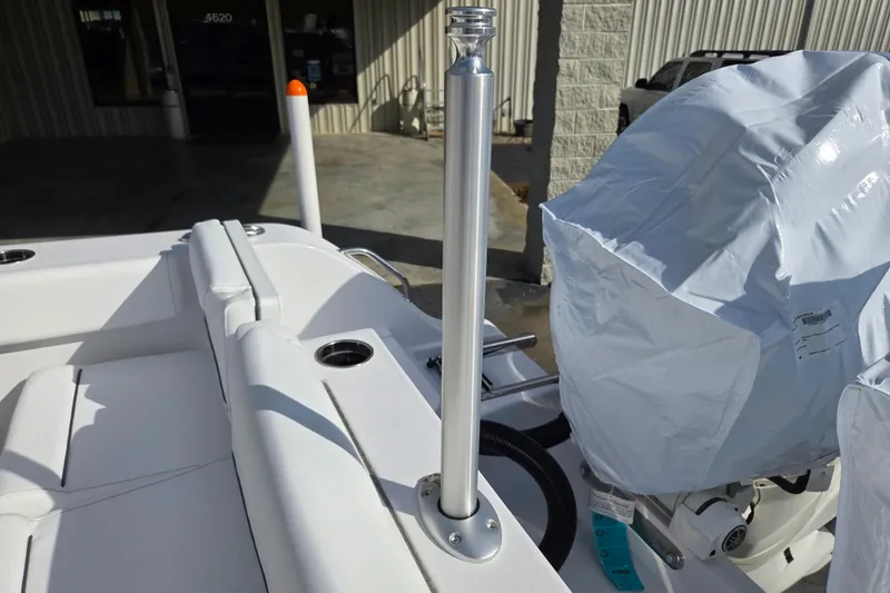 Slide: The Image of 2026 Sportsman Heritage 261 Center Console boat interior with covered engine and seating. - 19