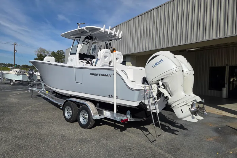 Slide: The Image of 2026 Sportsman Heritage 261 Center Console boat with Yamaha engines on a trailer. - 2