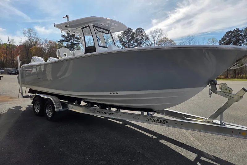 Slide: The Image of 2026 Sportsman Heritage 261 Center Console boat on trailer, parked outdoors. - 3
