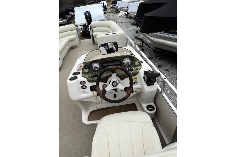 Slide: The Image of 2007 Harris Classic 240 I/O boat interior with steering wheel and dashboard controls. - 11