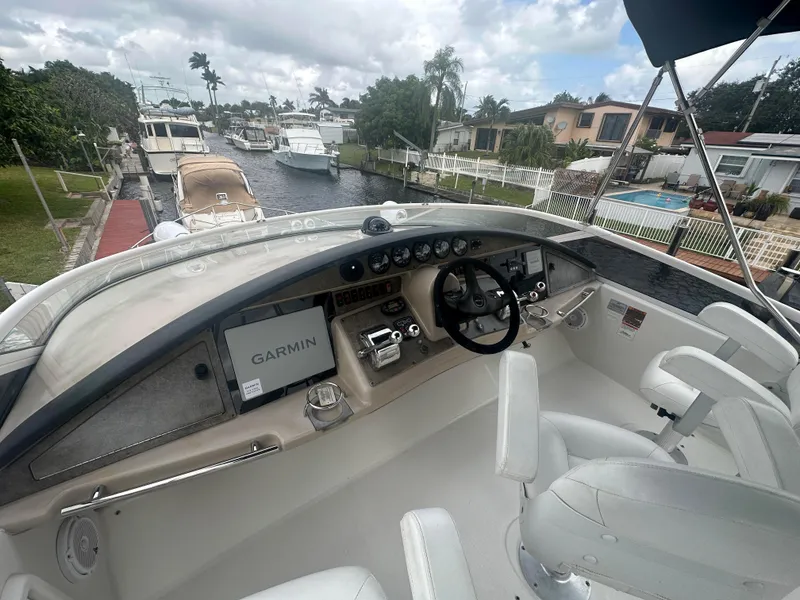 Slide: The Image of Carver 36 Super Sport 2005 yacht helm with Garmin navigation system, docked in a residential canal. - 13