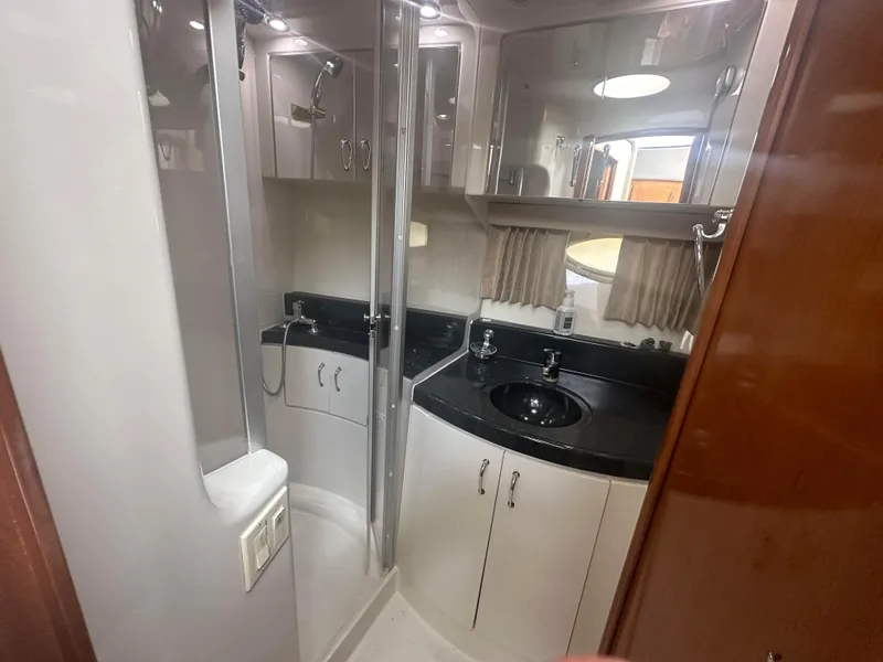 Slide: The Image of 2005 Carver 36 Super Sport yacht bathroom with shower, sink, and storage cabinets. - 20