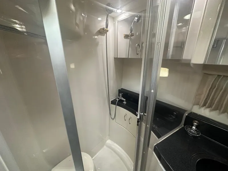 Slide: The Image of 2005 Carver 36 Super Sport yacht bathroom with shower and sink. - 21
