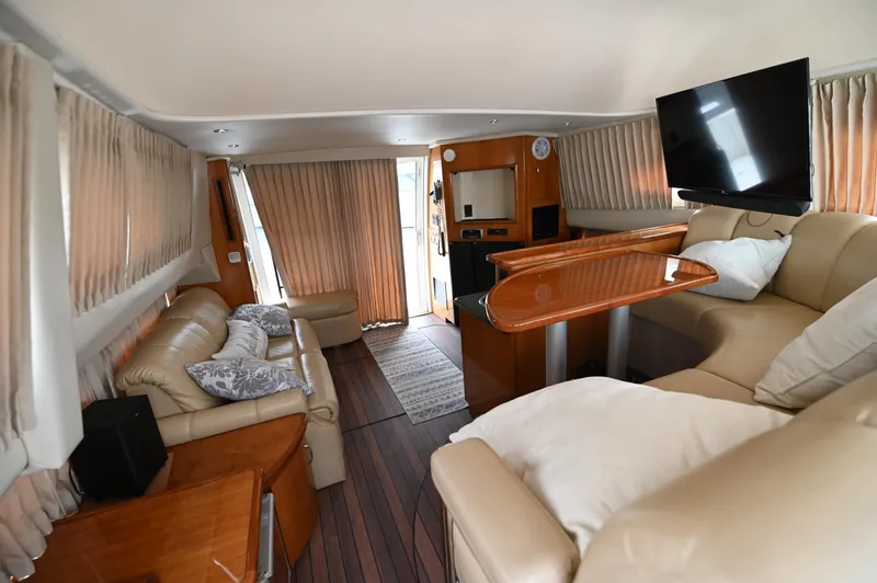 Slide: The Image of Interior of 2005 Carver 36 Super Sport yacht with leather seating and mounted TV. - 34
