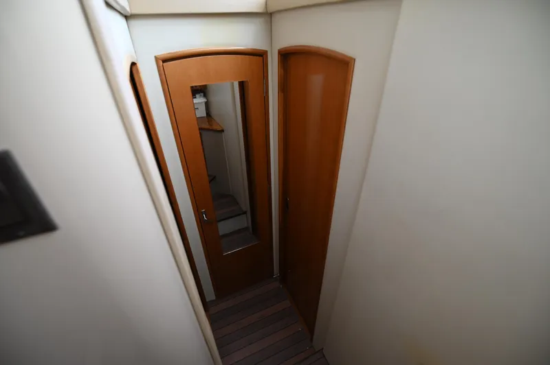 Slide: The Image of Narrow hallway inside 2005 Carver 36 Super Sport yacht with wooden doors. - 35