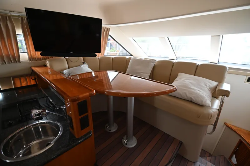 Slide: The Image of Interior of 2005 Carver 36 Super Sport yacht with leather seating, TV, and kitchenette. - 39