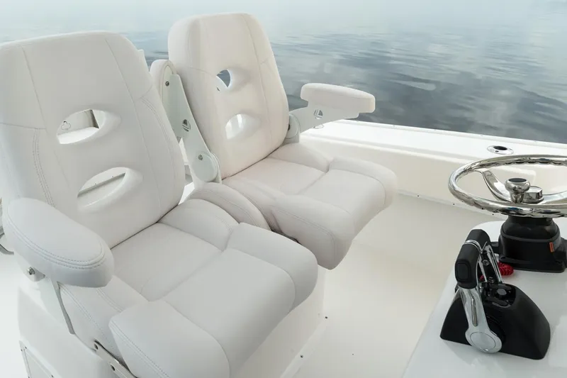Slide: The Image of Manufacturer Provided Image: 2026 Cape Horn 24 OS boat interior with white captain seats and steering wheel. - 10