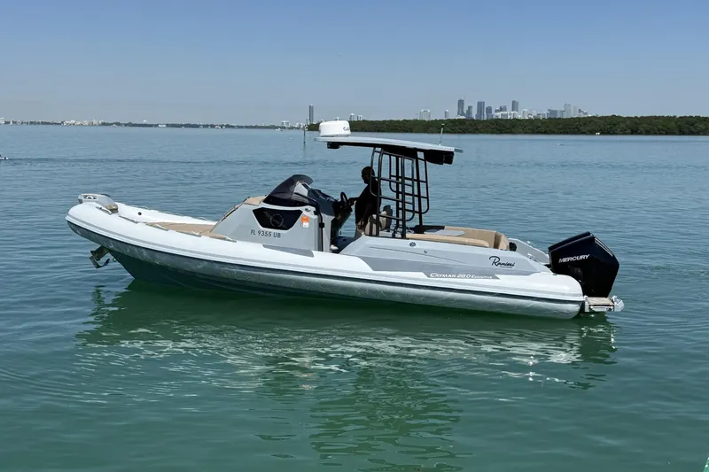 The Image of 2026 Ranieri Cayman Executive boat on calm water with city skyline in background. - 0