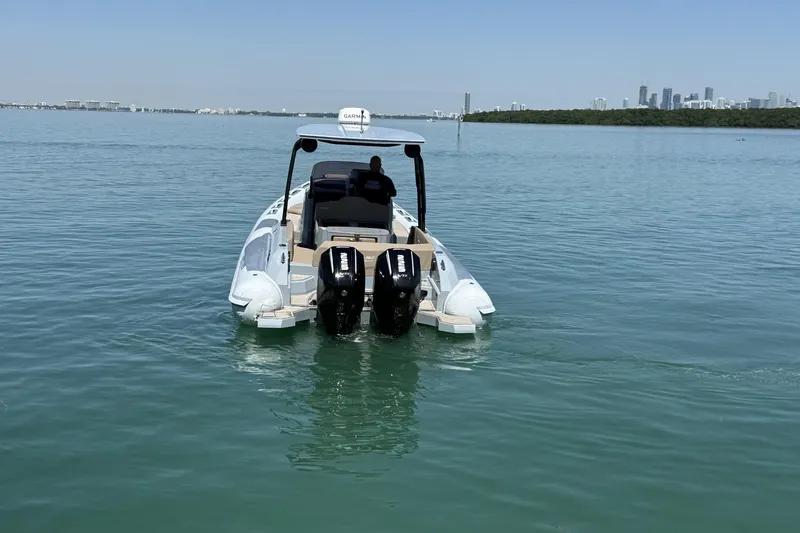 Slide: The Image of 2026 Ranieri Cayman Executive boat on calm water with city skyline in background. - 12