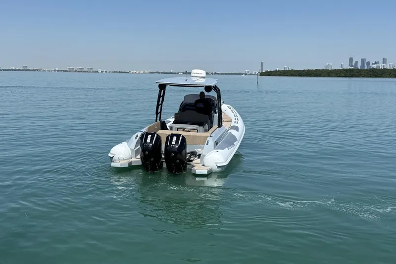 Slide: The Image of 2026 Ranieri Cayman Executive boat on calm water with city skyline in background. - 13