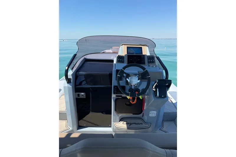 Slide: The Image of 2026 Ranieri Cayman Executive boat cockpit with steering wheel and navigation controls. - 17