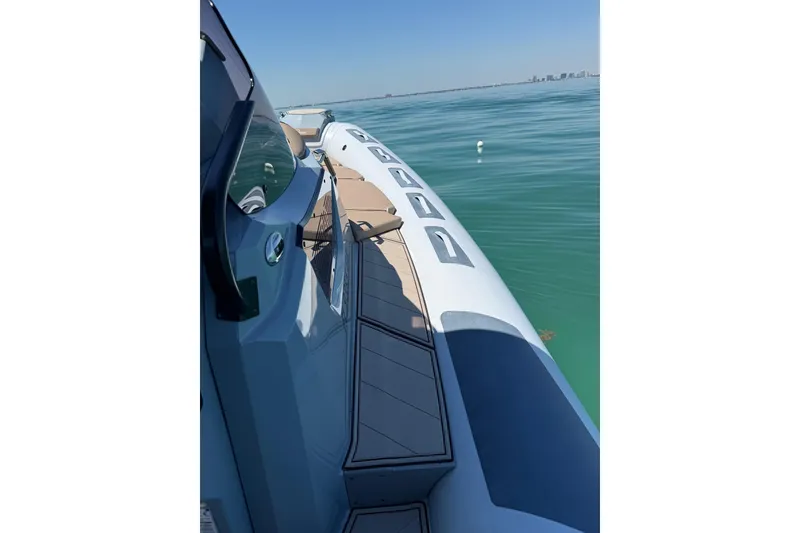 Slide: The Image of 2026 Ranieri Cayman Executive boat on calm blue water, showcasing sleek design. - 18