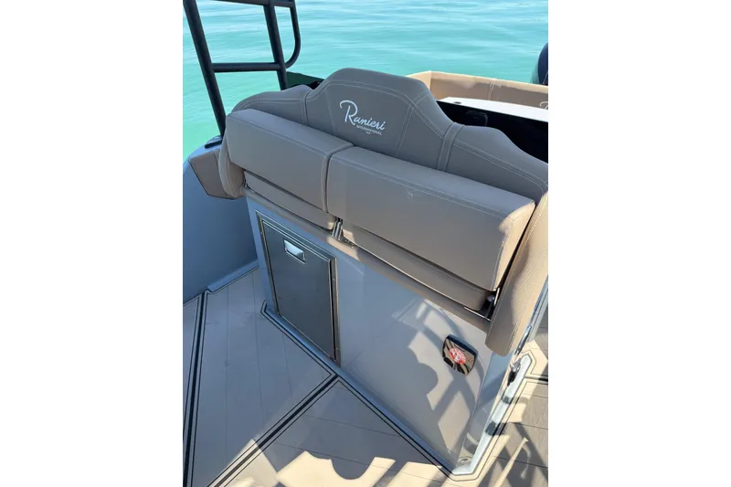 Slide: The Image of 2026 Ranieri Cayman Executive boat interior with cushioned seating and storage. - 21