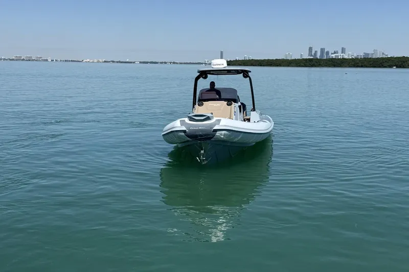 Slide: The Image of 2026 Ranieri Cayman Executive boat on calm water with city skyline in background. - 3