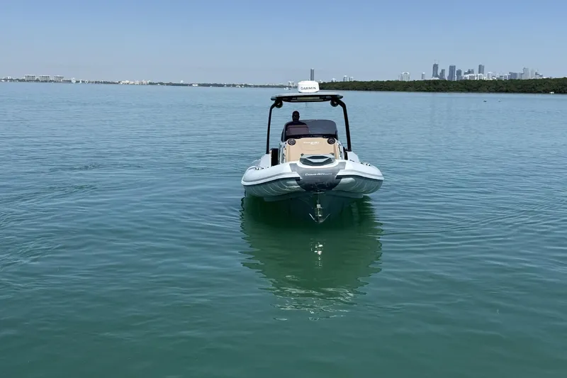 Slide: The Image of 2026 Ranieri Cayman Executive boat on calm water with city skyline in background. - 4