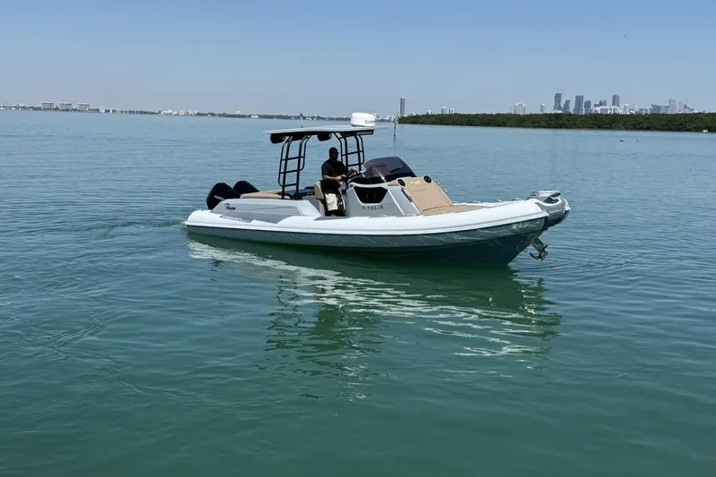 Slide: The Image of Ranieri Cayman Executive 2026 on calm water with city skyline in background. - 6