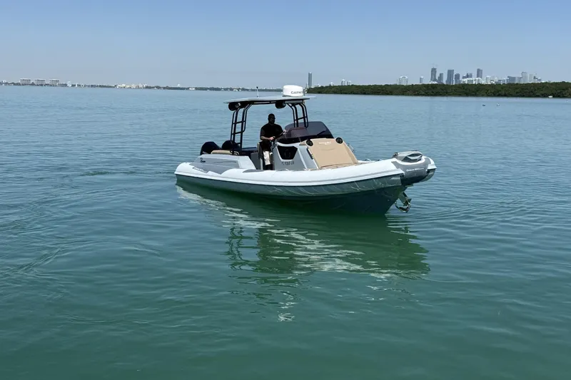 Slide: The Image of 2026 Ranieri Cayman Executive boat on calm water with city skyline in background. - 7