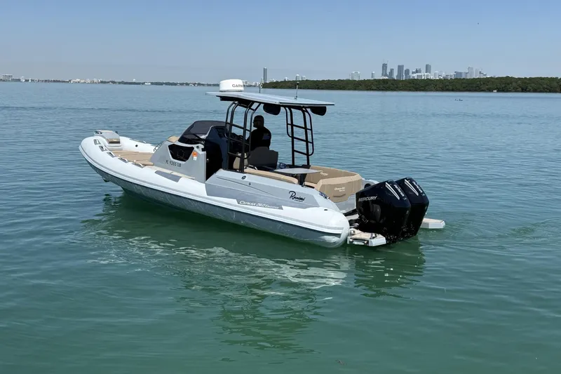 Slide: The Image of 2026 Ranieri Cayman Executive boat on calm water with city skyline in background. - 9