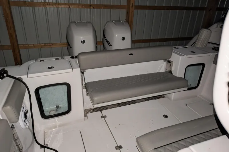 Slide: The Image of 2022 Sportsman Open 322 Center Console boat interior with seating and dual Mercury engines. - 10