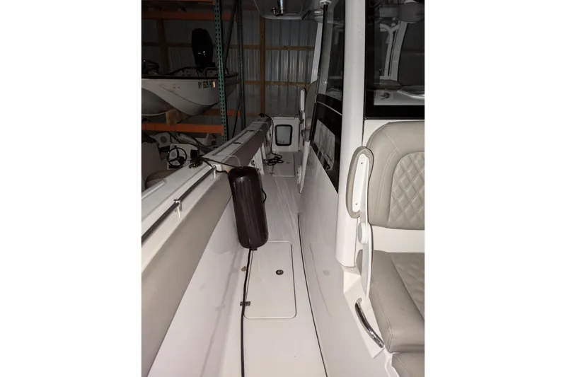 Slide: The Image of 2022 Sportsman Open 322 Center Console boat interior with seating and storage. - 11