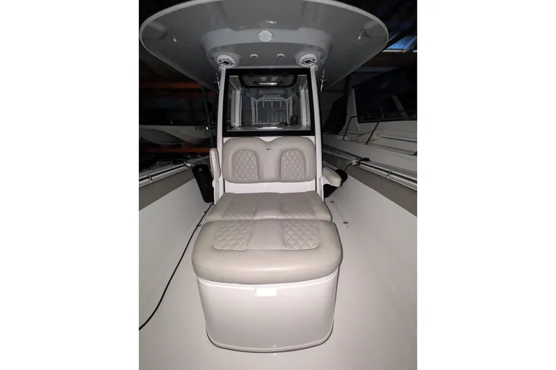 Slide: The Image of 2022 Sportsman Open 322 Center Console boat interior with cushioned seating. - 13
