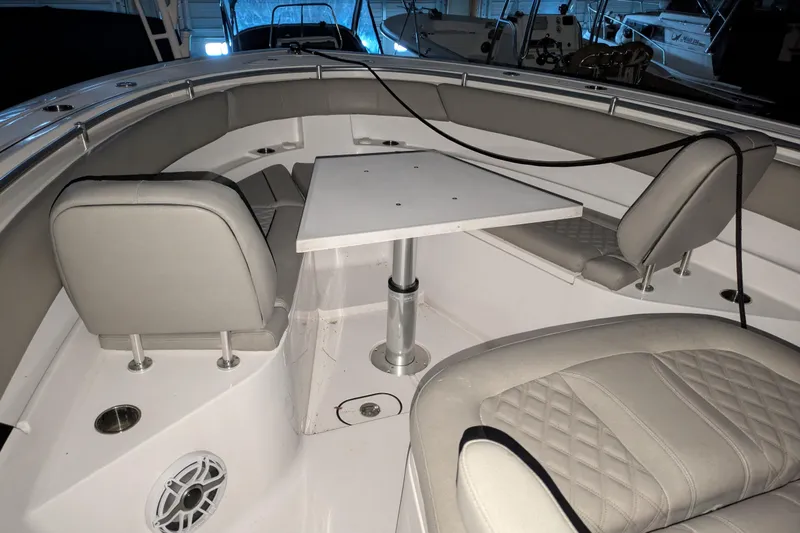 Slide: The Image of 2022 Sportsman Open 322 Center Console boat interior with seating and table. - 14