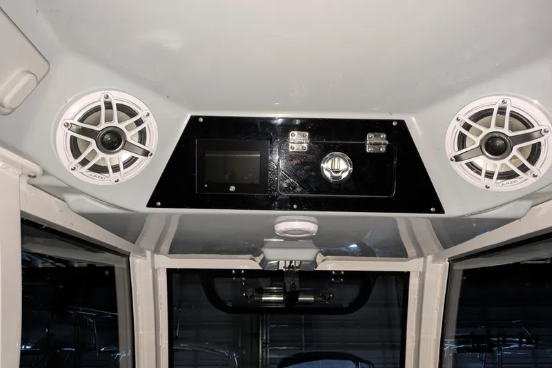 Slide: The Image of 2022 Sportsman Open 322 Center Console interior with JL Audio speakers and control panel. - 18