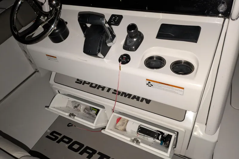 Slide: The Image of 2022 Sportsman Open 322 Center Console dashboard with steering wheel and controls. - 9