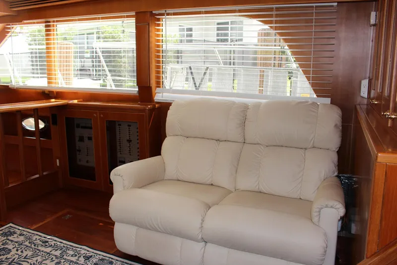 Slide: The Image of Interior of 2007 Jefferson 45 Motor Yacht with beige sofa and wooden paneling. - 11