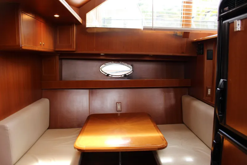 Slide: The Image of Interior of 2007 Jefferson 45 Motor Yacht with wooden dining area and seating. - 13