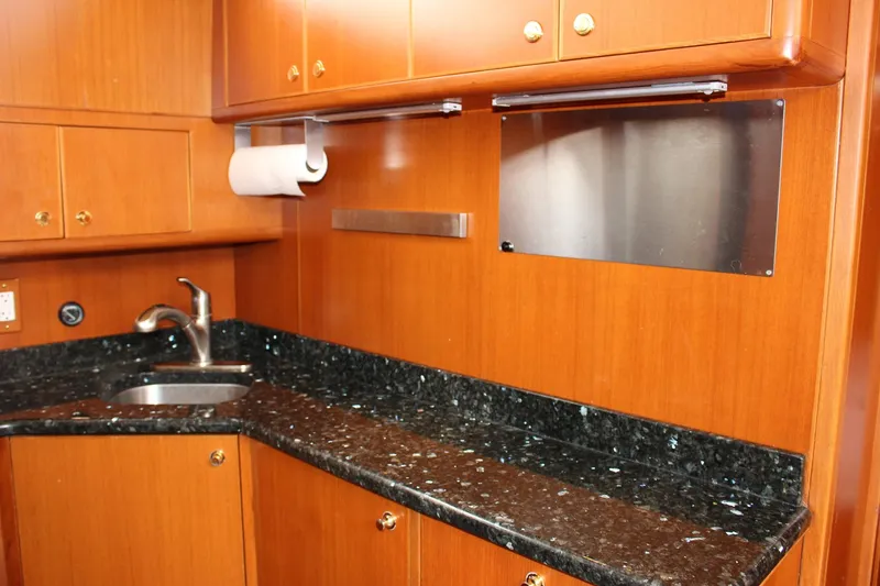 Slide: The Image of Luxurious kitchen area in a 2007 Jefferson 45 Motor Yacht with granite countertops. - 15